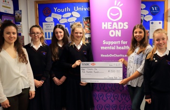 Davison CE High School girls presenting a £500 cheque to Heads On